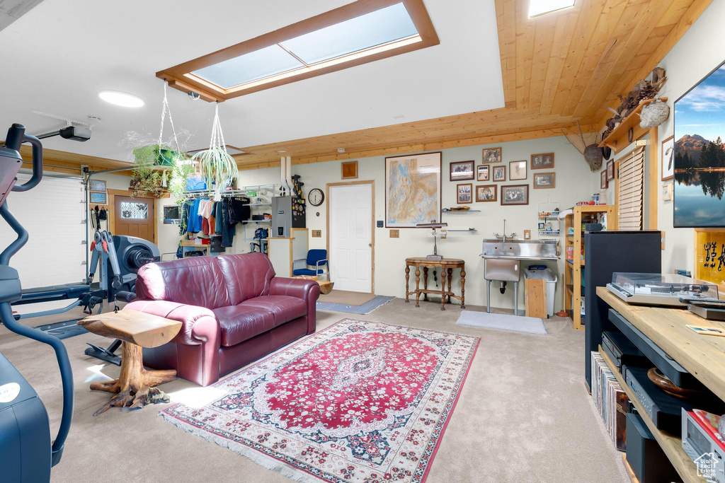 Living room featuring carpet, a workshop area, and a skylight