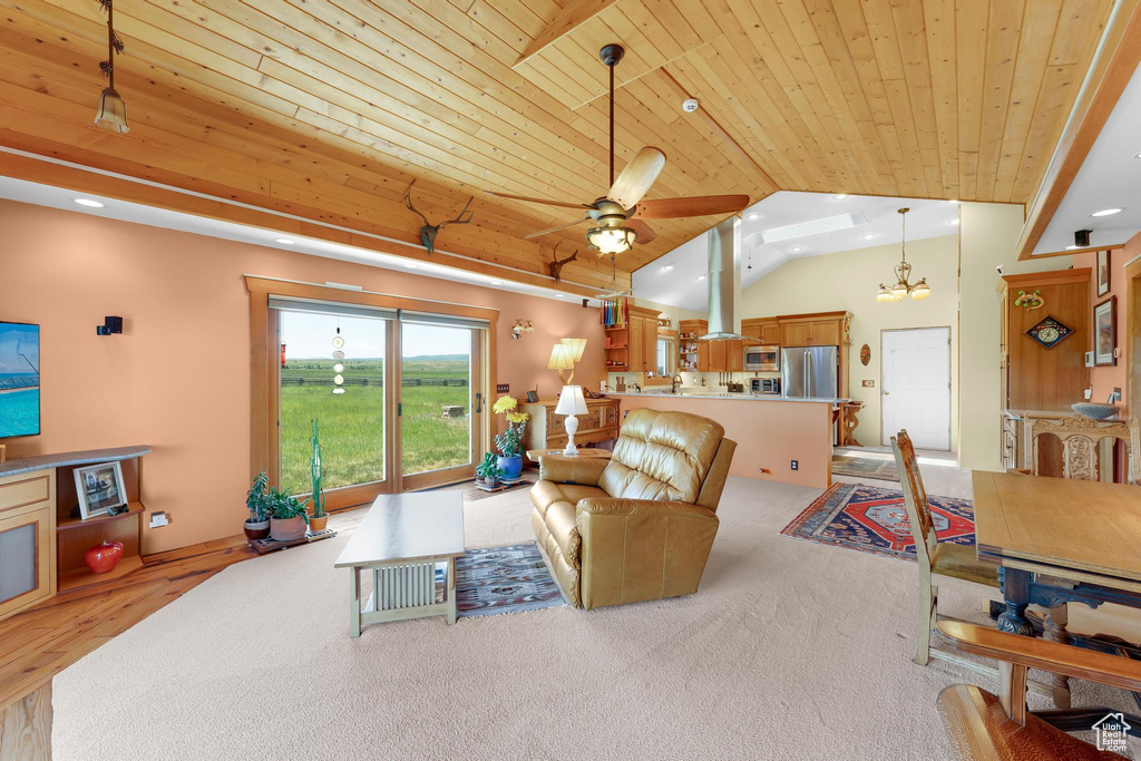 Living room featuring wood ceiling, lofted ceiling, a ceiling fan, recessed lighting, and light carpet