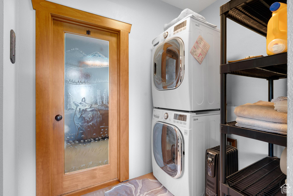 Laundry room featuring estacked washer and dryer