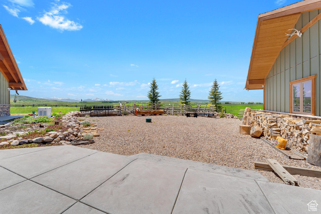 View of patio / terrace with a mountain view and a rural view