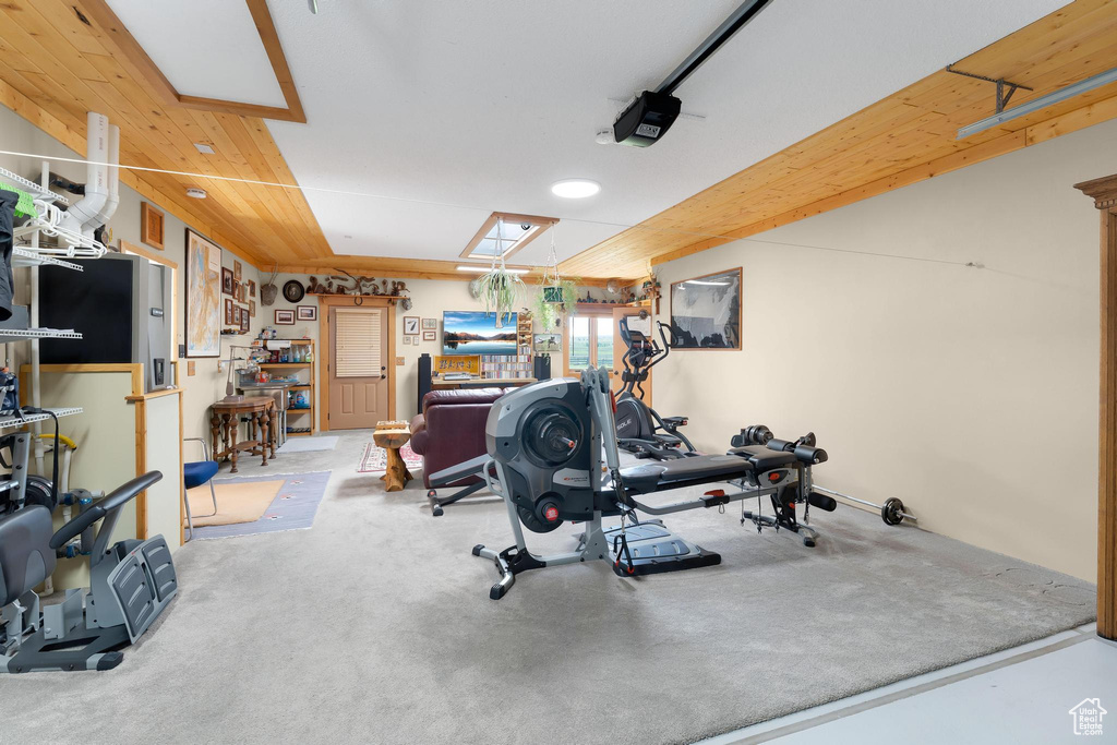Workout room with carpet and a garage