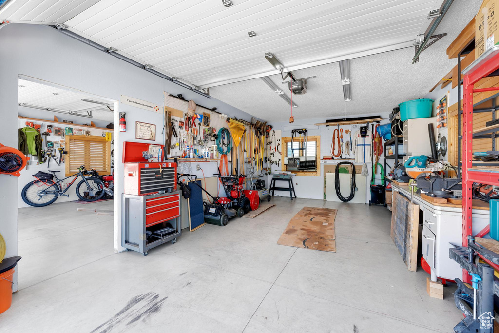 Garage with a workshop area and a garage door opener