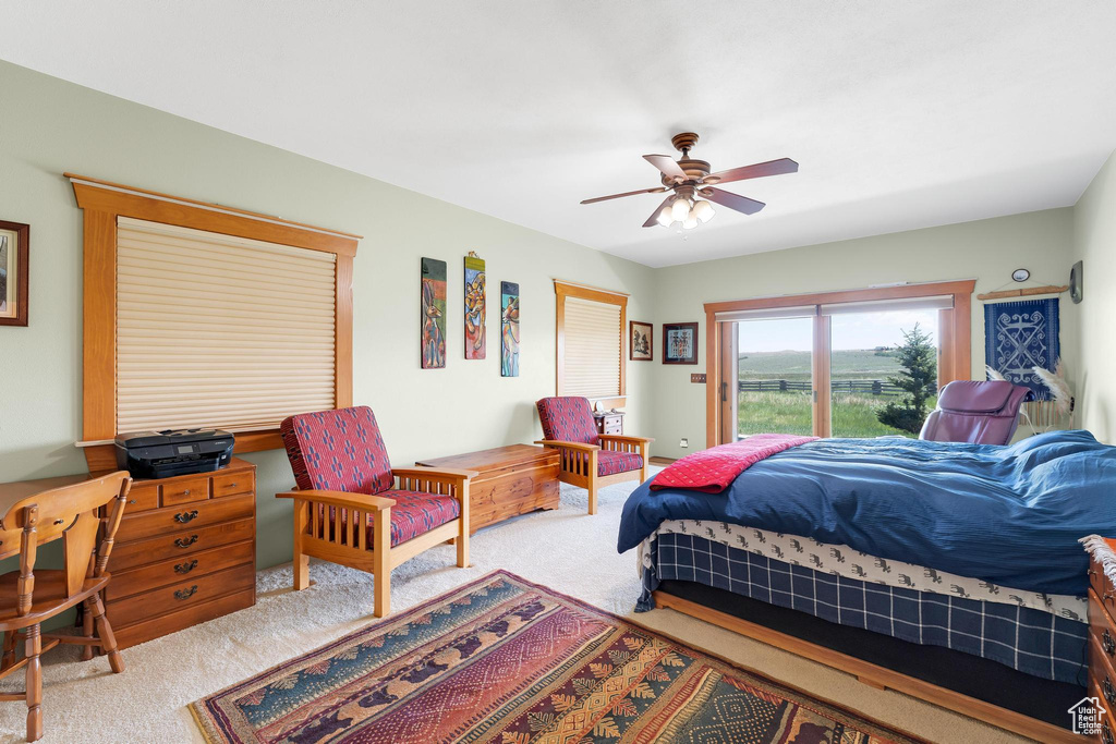 Bedroom featuring carpet, access to outside, and a ceiling fan