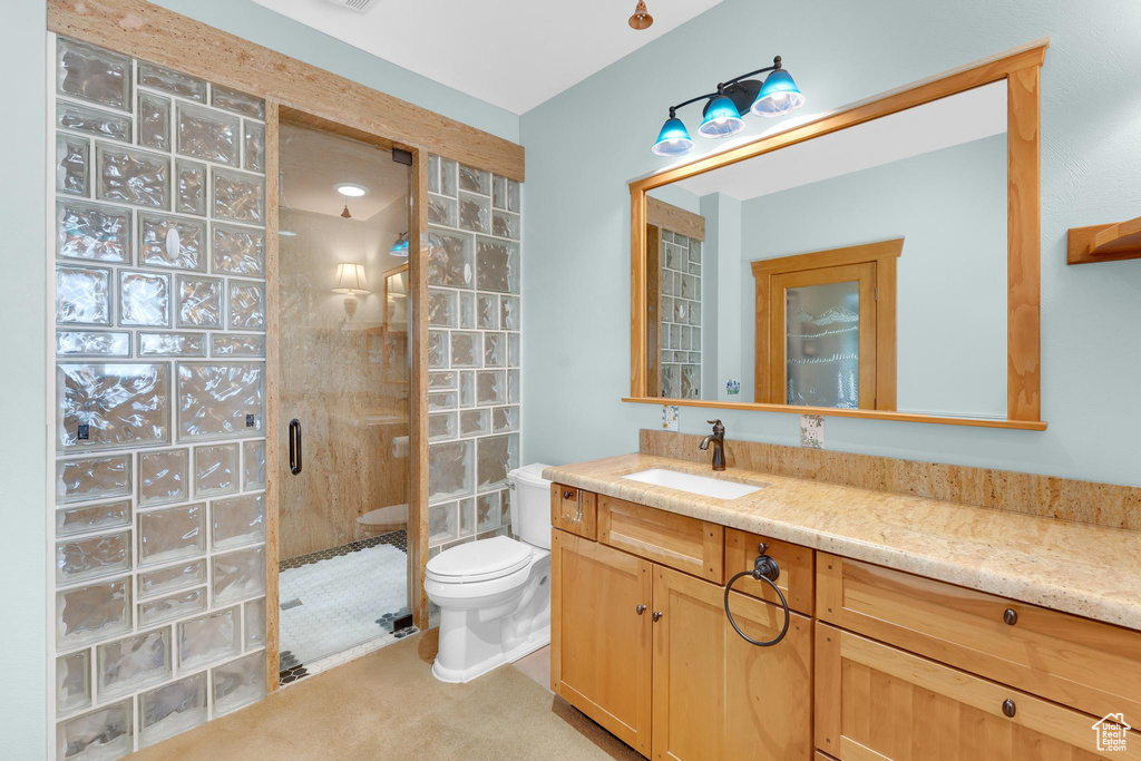 Bathroom with a shower stall and vanity