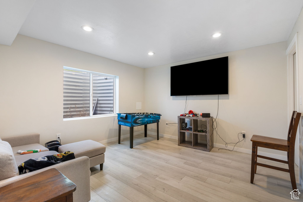 Living area featuring light wood-type flooring and recessed lighting