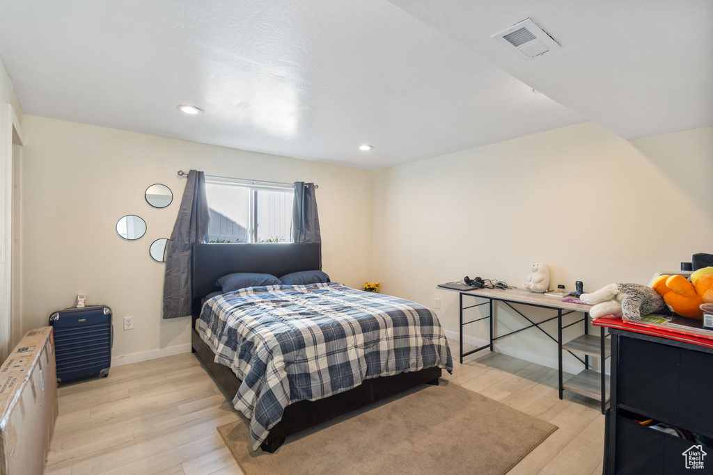 Bedroom with light wood-type flooring and recessed lighting
