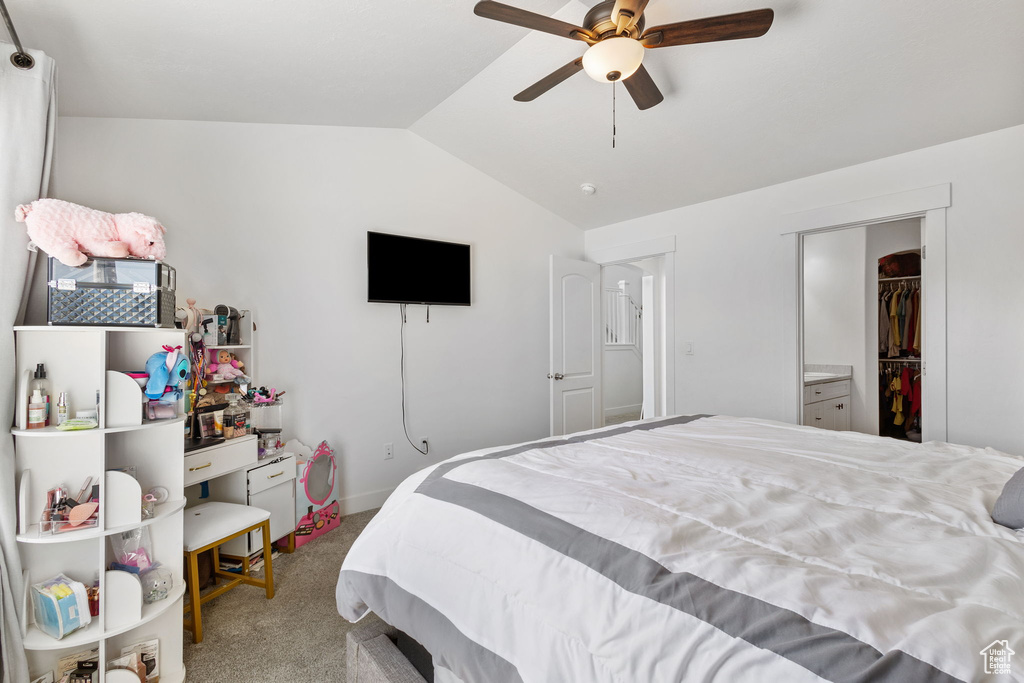Bedroom featuring vaulted ceiling, carpet flooring, and ceiling fan