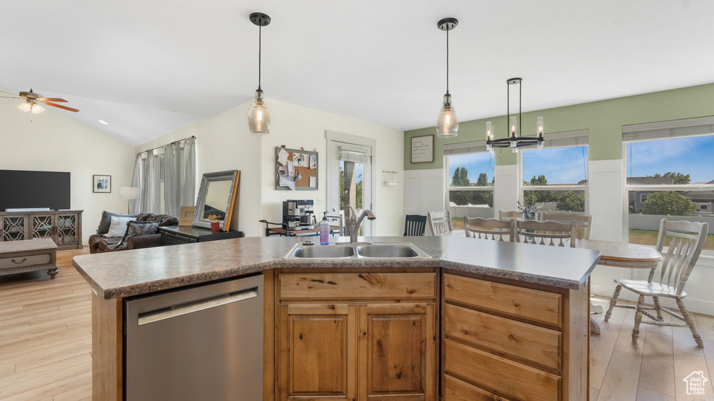 Kitchen featuring dishwasher, ceiling fan, open floor plan, light wood finished floors, and plenty of natural light