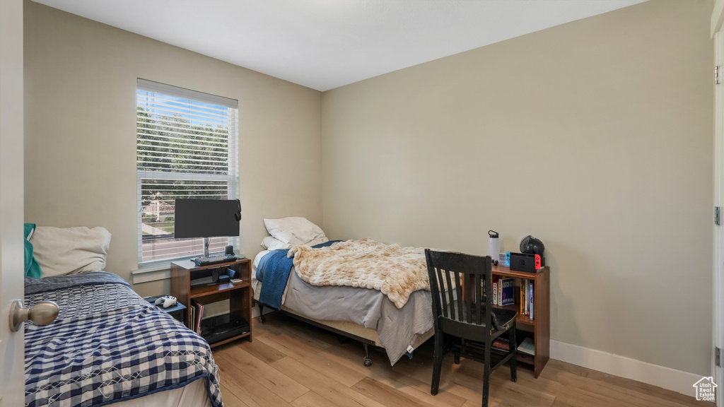 Bedroom featuring light wood finished floors and baseboards