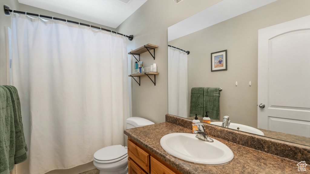 Full bathroom with vanity and curtained shower