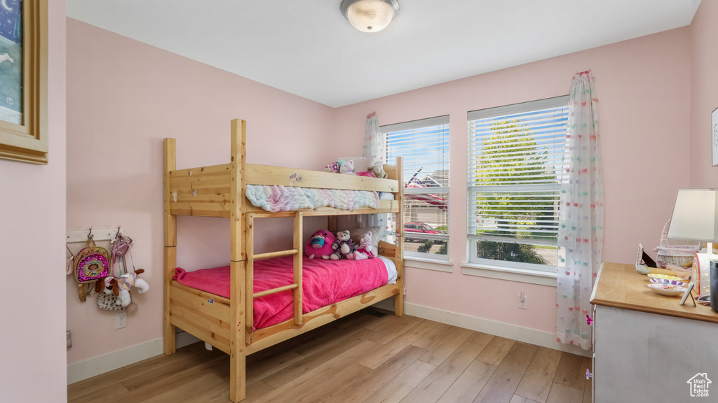 Bedroom featuring wood finished floors and baseboards