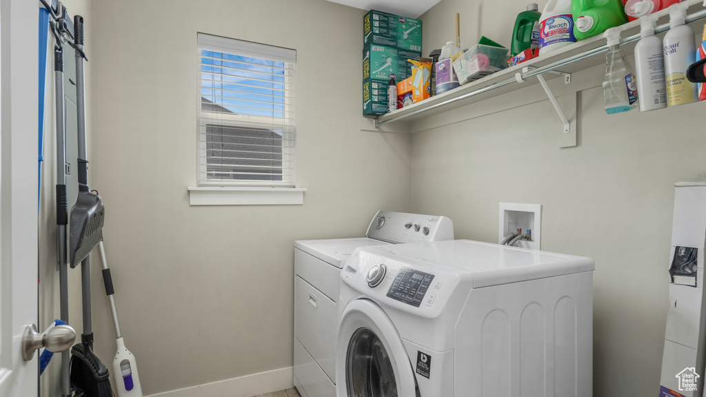 Washroom featuring washer and clothes dryer and baseboards