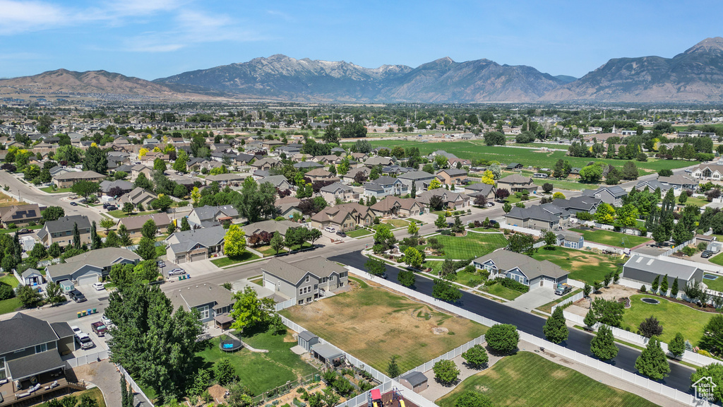 Aerial perspective of suburban area featuring a mountainous background