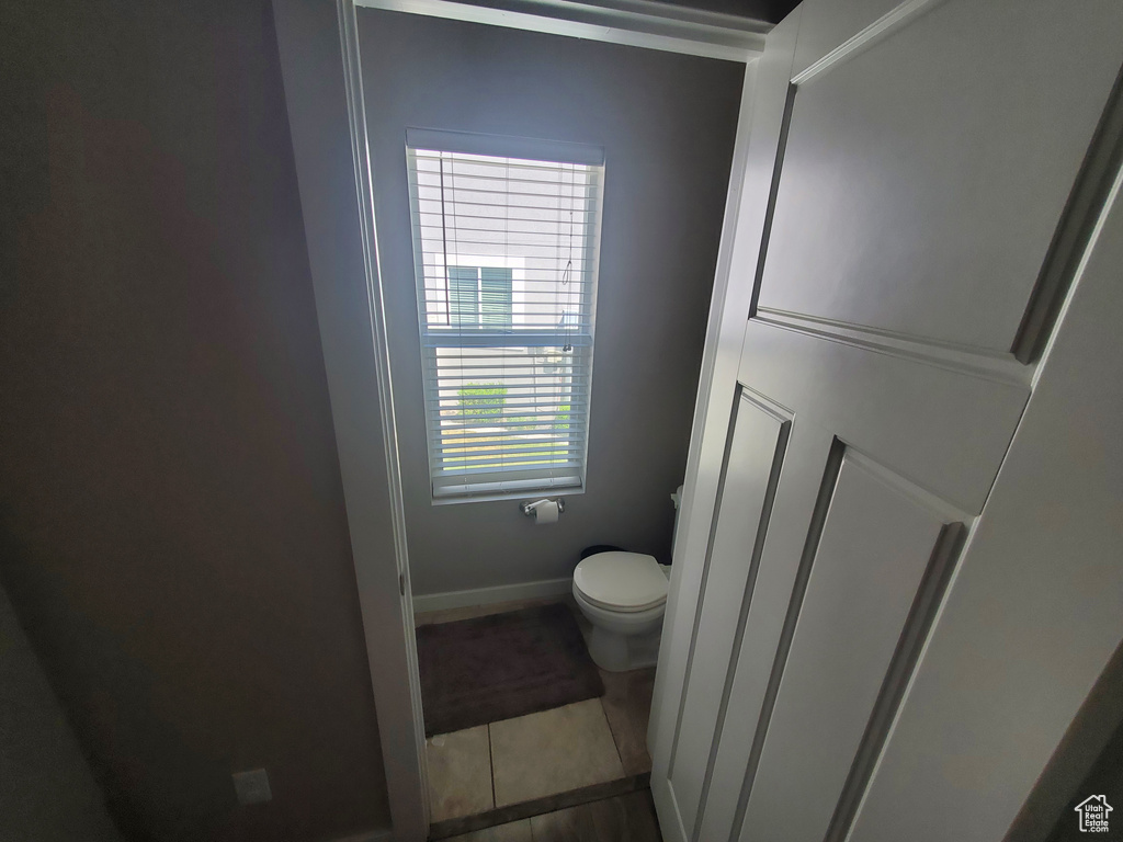 Bathroom with toilet and tile patterned floors