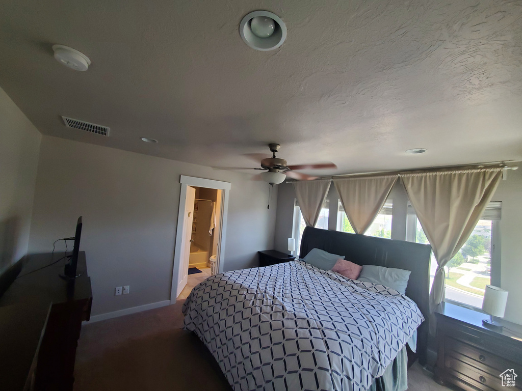 Bedroom featuring multiple windows and carpet floors