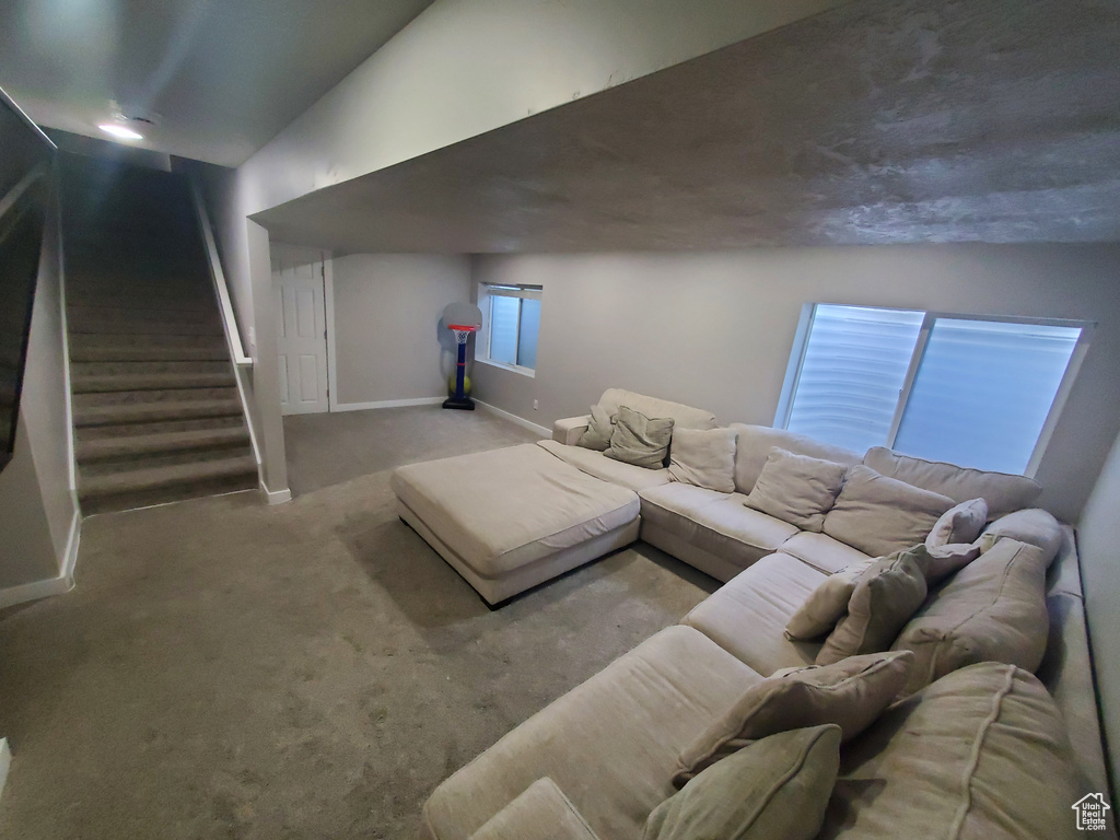 Carpeted living room with baseboards and stairway