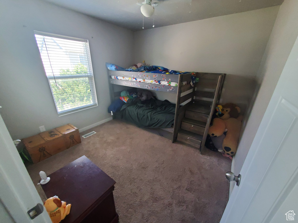 Bedroom featuring carpet floors and baseboards