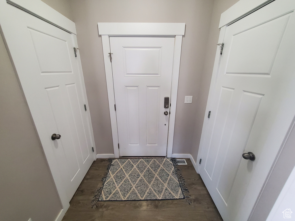 Doorway to outside featuring dark wood finished floors