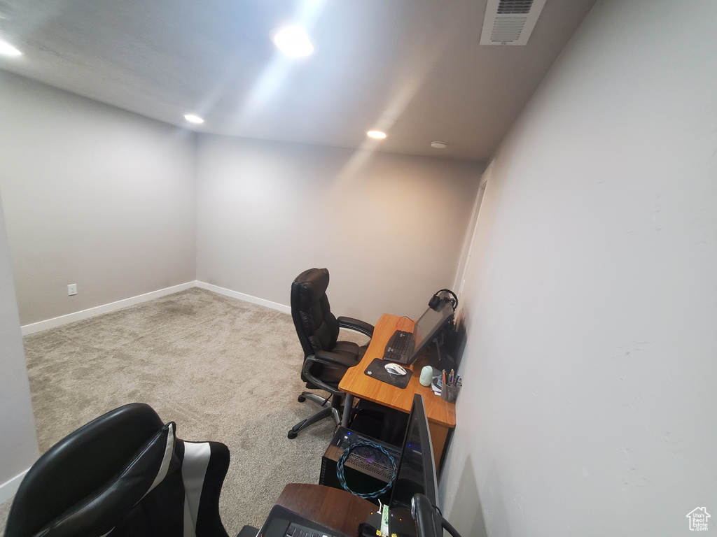 Carpeted office featuring recessed lighting