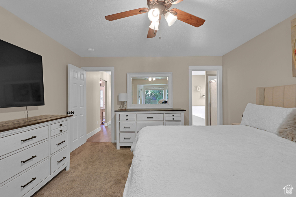 Bedroom featuring light colored carpet and a ceiling fan