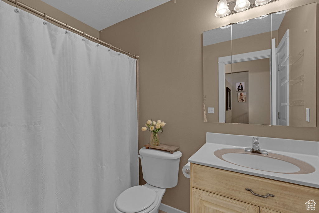 Bathroom with vanity and a shower with shower curtain