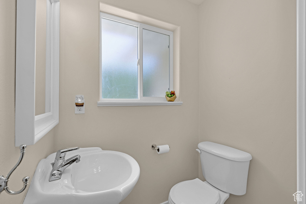 Half bathroom with toilet and a sink