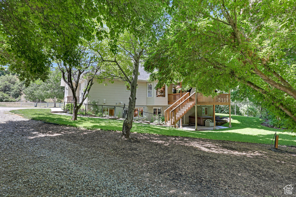 Back of property featuring stairway and a wooden deck