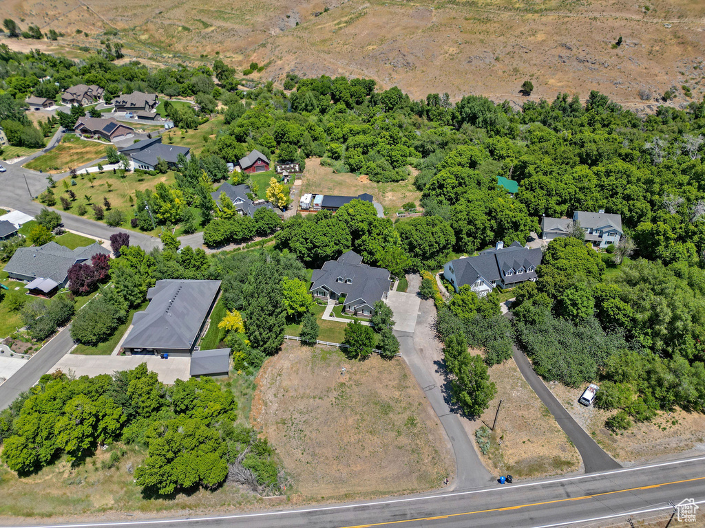 Aerial view of property and surrounding area with nearby suburban area