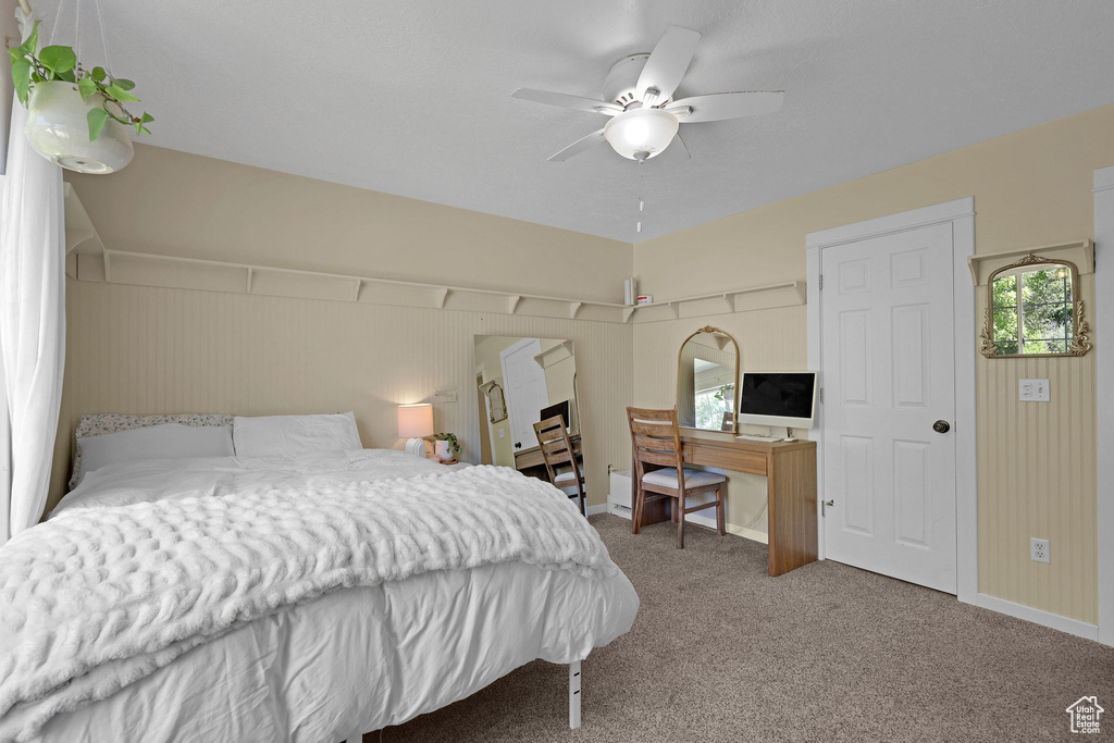 Bedroom featuring multiple windows, carpet flooring, and ceiling fan