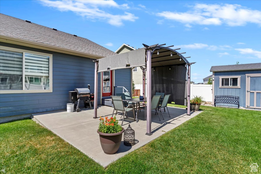View of patio / terrace with area for grilling and a storage unit