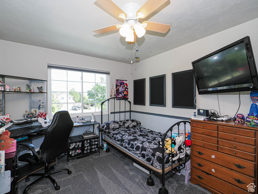 Bedroom with carpet flooring, a desk, and a ceiling fan