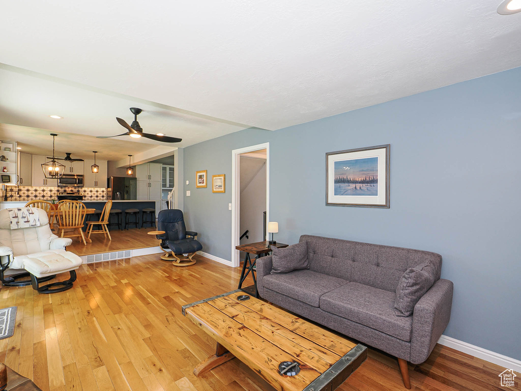 Living room featuring light wood-style flooring and ceiling fan