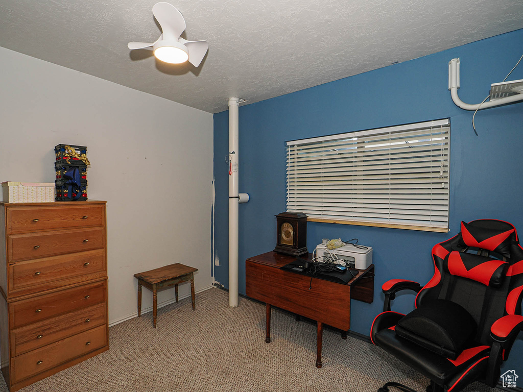 Carpeted office featuring ceiling fan