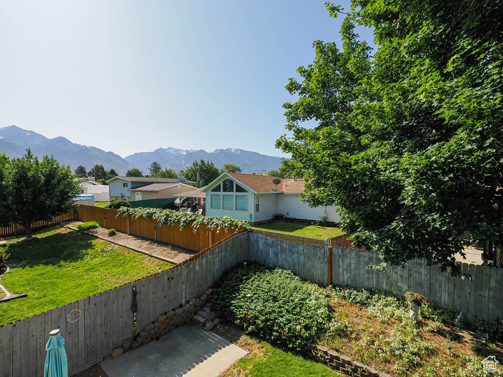 Fenced backyard featuring a mountain view
