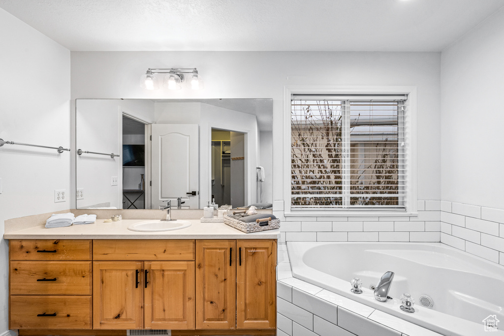 Full bathroom with a bath and vanity