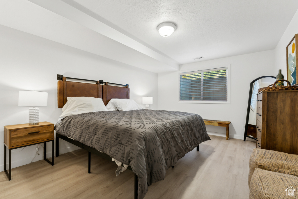 Bedroom featuring light wood finished floors and baseboards