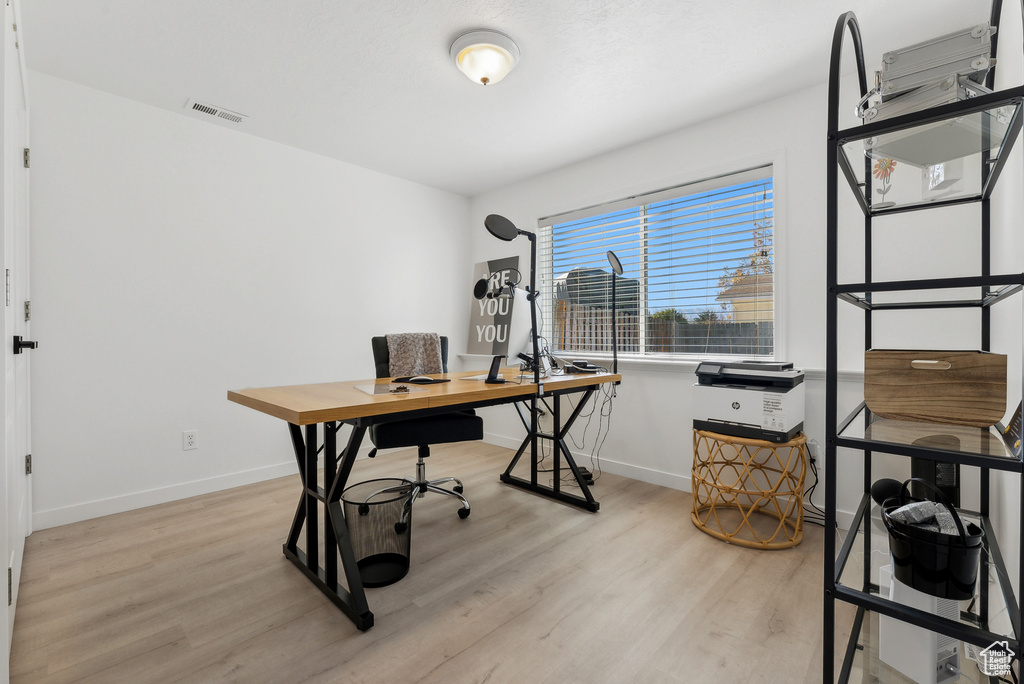 Office space featuring light wood-style floors