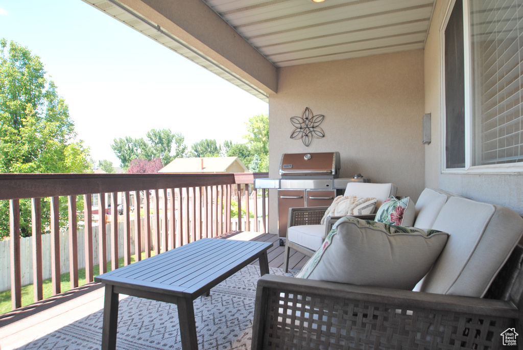 Deck with an outdoor hangout area and a grill