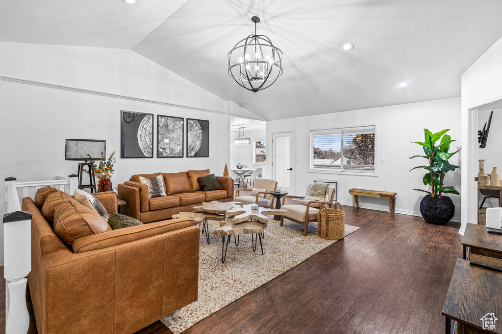 Living room featuring vaulted ceiling, a chandelier, wood finished floors, and recessed lighting