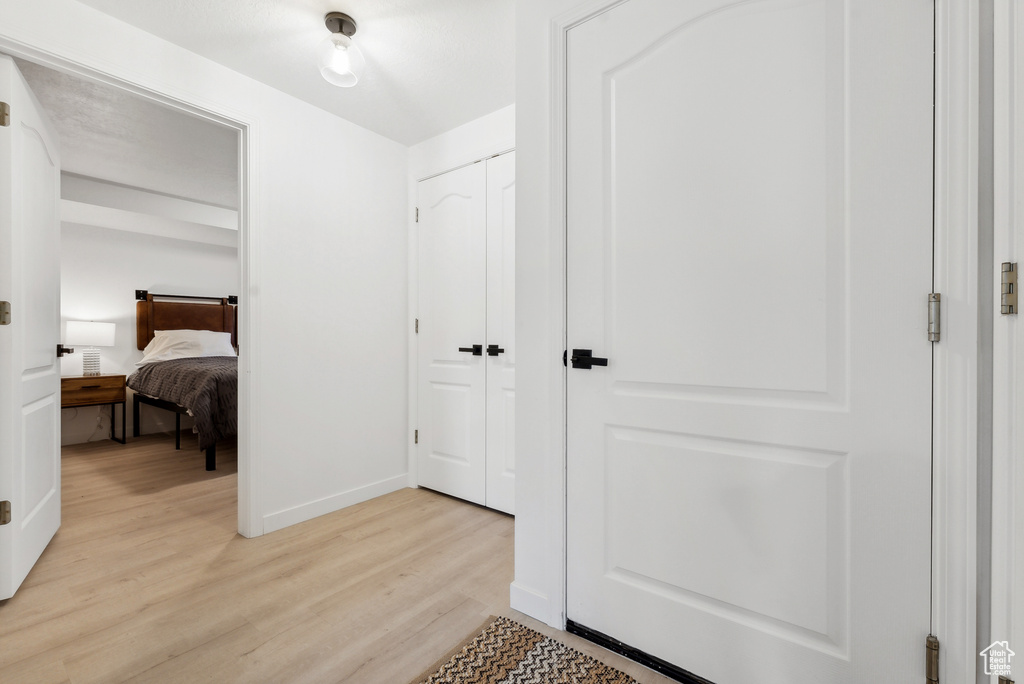 Hallway with light wood finished floors and baseboards