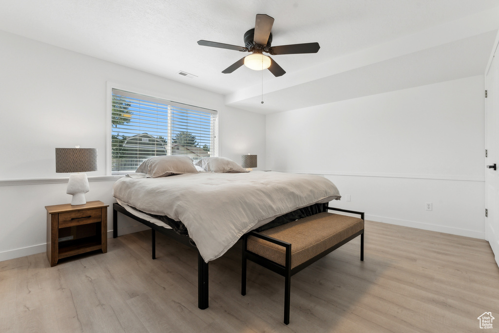 Bedroom with light wood-style floors and ceiling fan