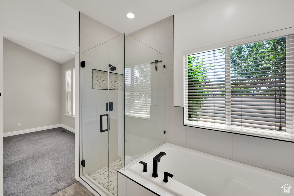 Bathroom featuring a garden tub, a shower stall, and recessed lighting