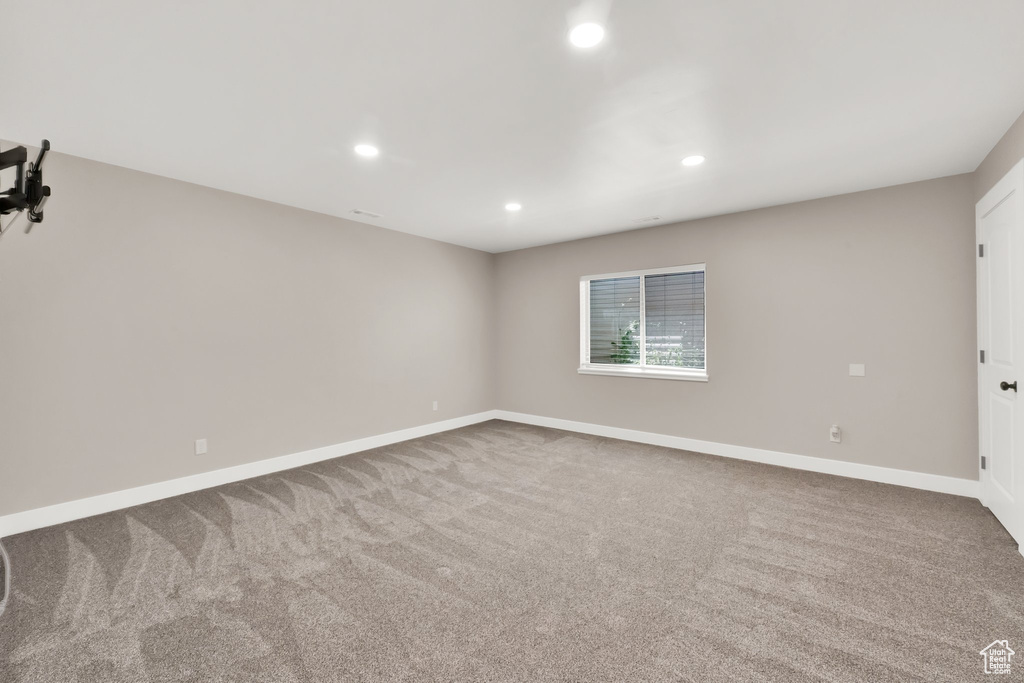 Unfurnished room featuring recessed lighting and carpet