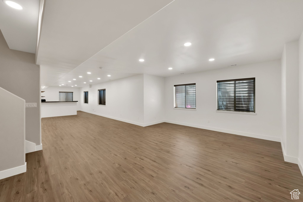 Unfurnished living room with wood finished floors and recessed lighting