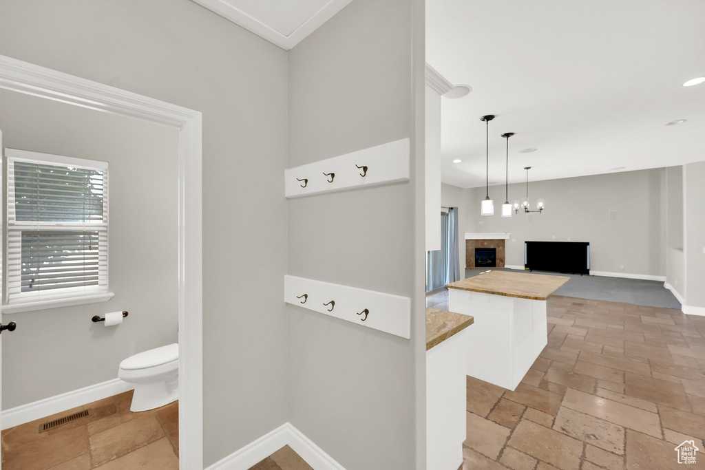 Bathroom with stone tile floors and recessed lighting