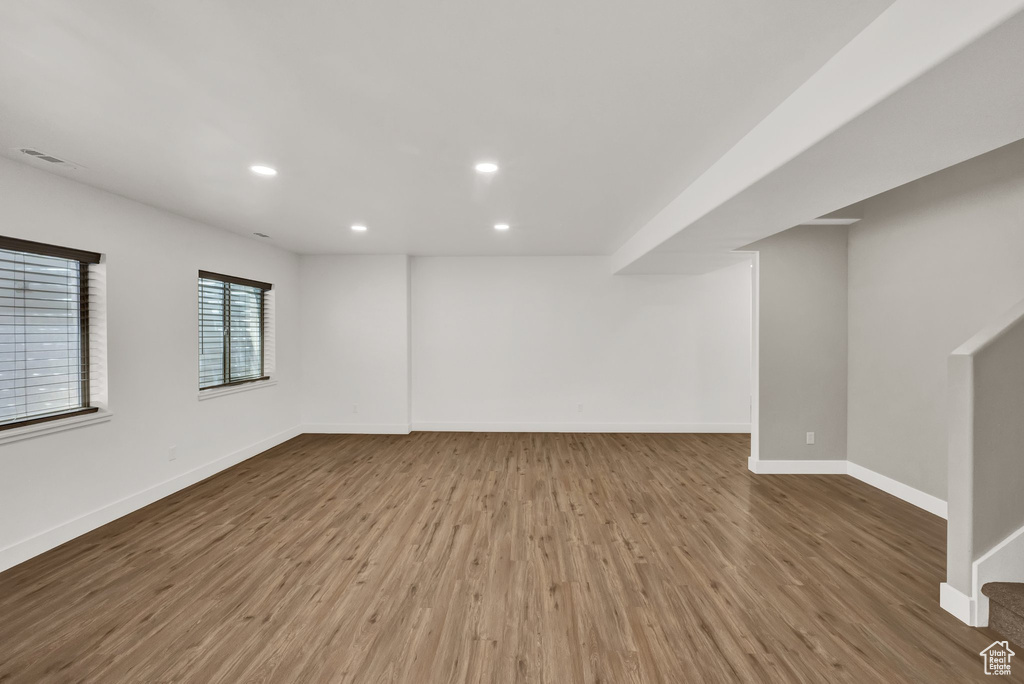 Below grade area with wood finished floors and recessed lighting