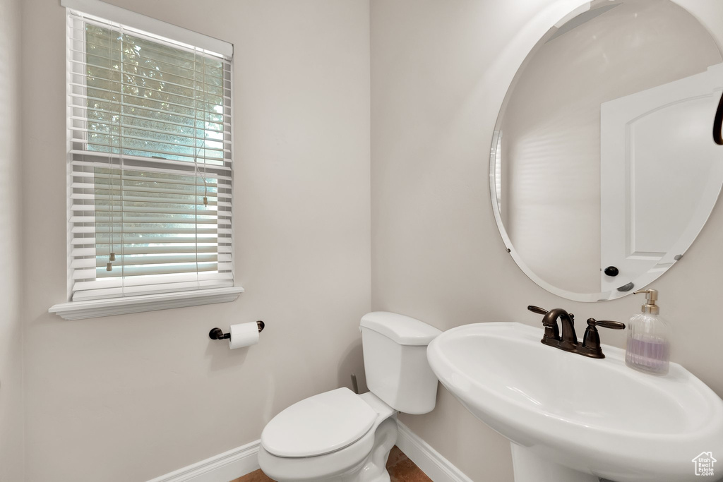 Bathroom featuring a sink and baseboards