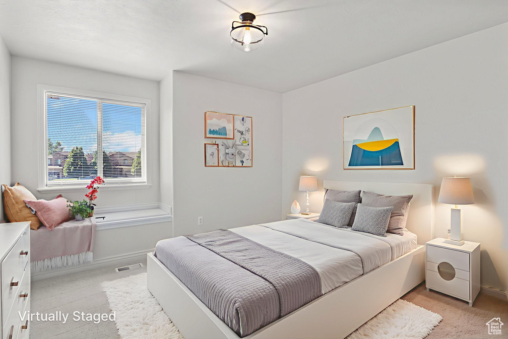 Bedroom with light carpet