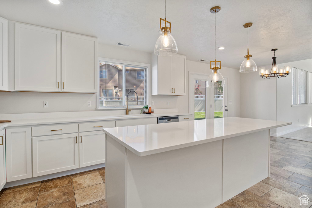 Kitchen with stone tile floors, recessed lighting, white cabinetry, and light countertops