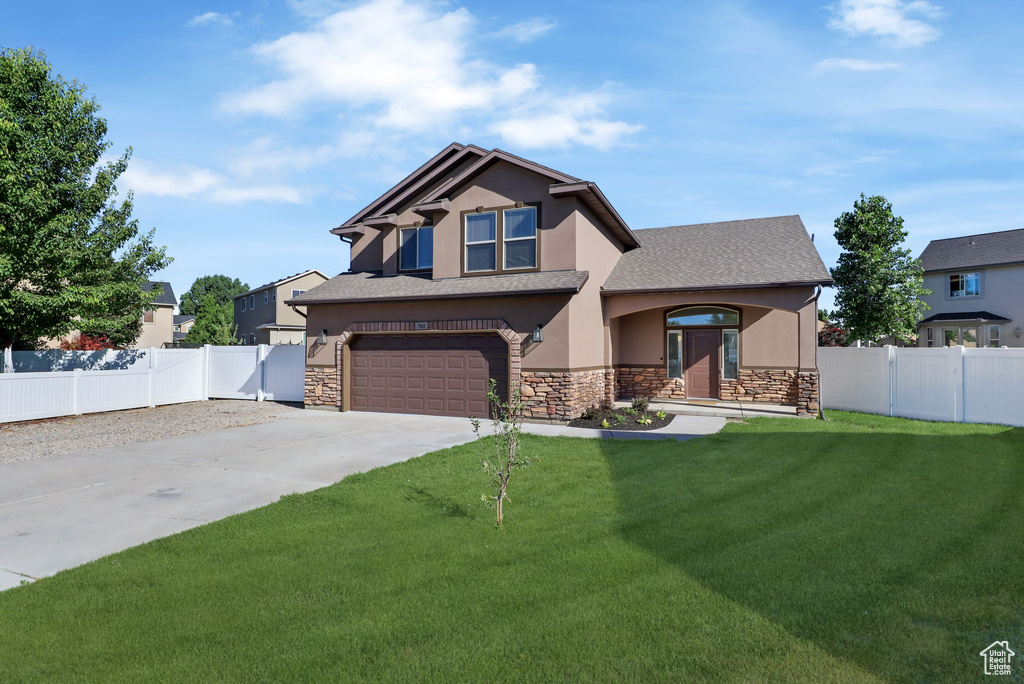 Craftsman house featuring stone siding, concrete driveway, stucco siding, and a garage